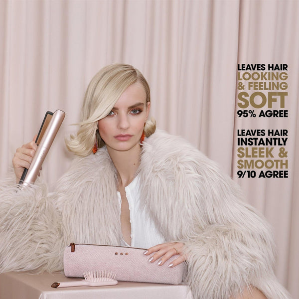 A blonde woman in a white faux fur coat holds a pink hair styling tool and a pink comb in front of a beige curtain backdrop. Text on the right reads 'LEAVES HAIR LOOKING & FEELING SOFT 95% AGREE' and 'LEAVES HAIR INSTANTLY SLEEK & SMOOTH 9/10 AGREE'.