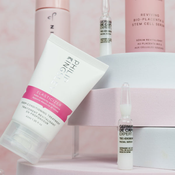 Skincare products on a pink and white background
