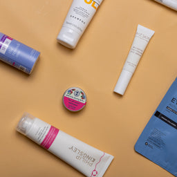 Various skincare products on a beige background