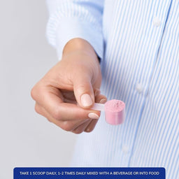 Hand holding a scoop of pink powder with text about daily intake.