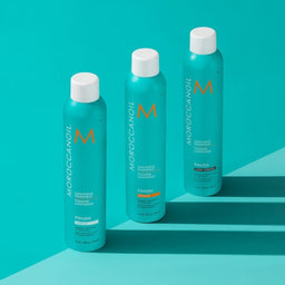 three bottles of Moroccanoil Luminous Hairspray Extra Strong aligned next to each other