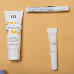 Collection of skincare and hair care products on a beige background