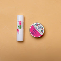 Lip balm and container on a beige background