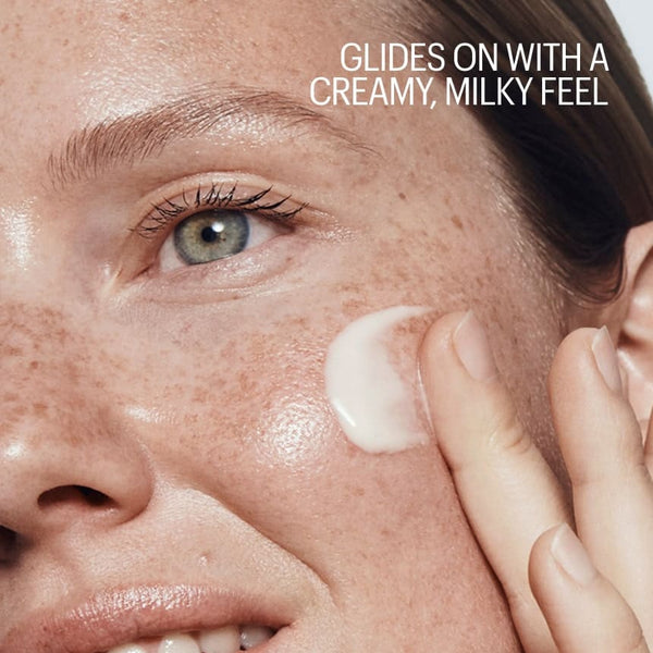 Person applying cream to their face with text about a creamy, milky feel