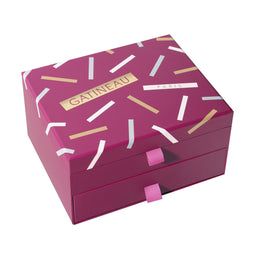 Pink jewelry box with white and gold accents on a white background