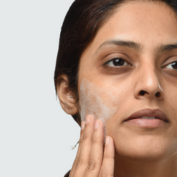 a closeup of a women applying Minimalist Aquaporin Booster 05% Cleanser to her face