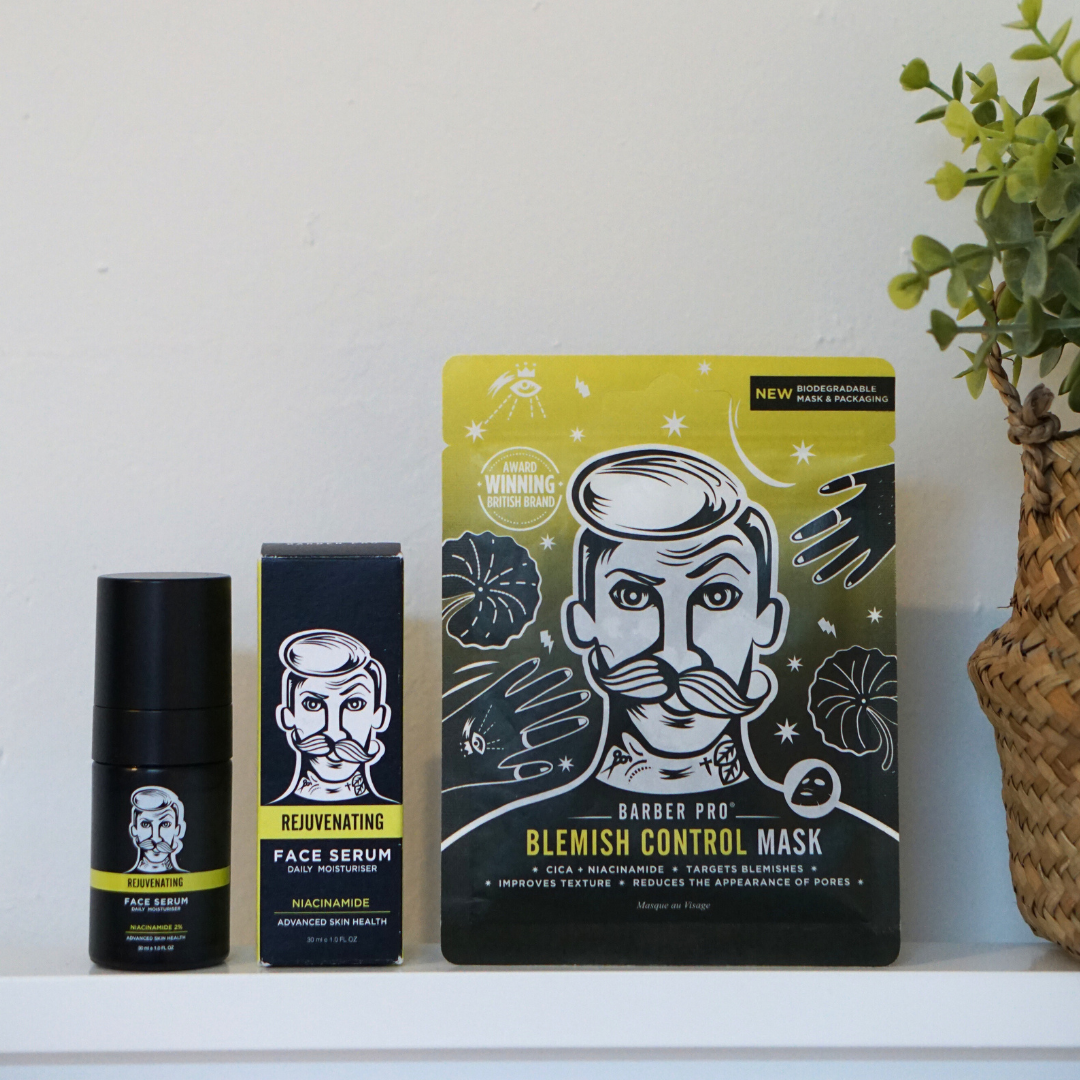 Two skincare products on a white surface with a plant in the background
