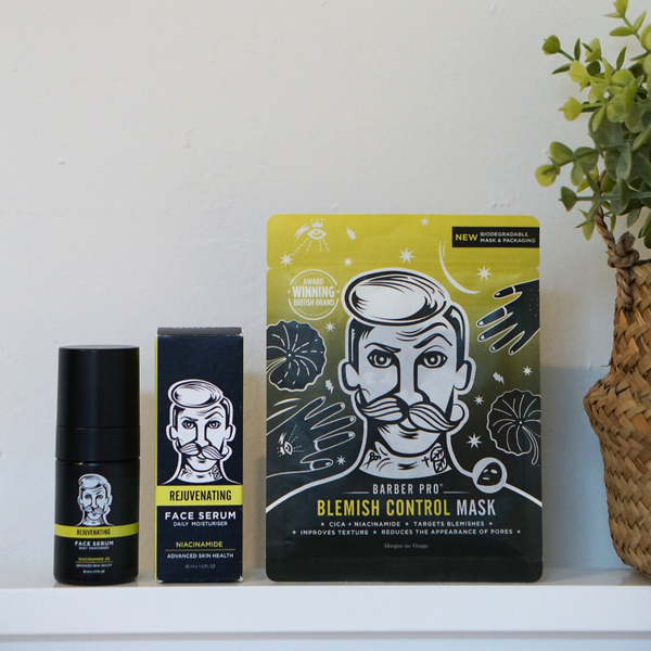 Two skincare products on a white surface with a plant in the background