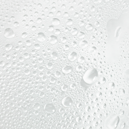 Close-up of water droplets on a white surface