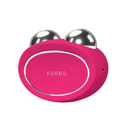 A pink FOREEO facial massage device with two metallic silver ball rollers on top, shown on a plain white background.