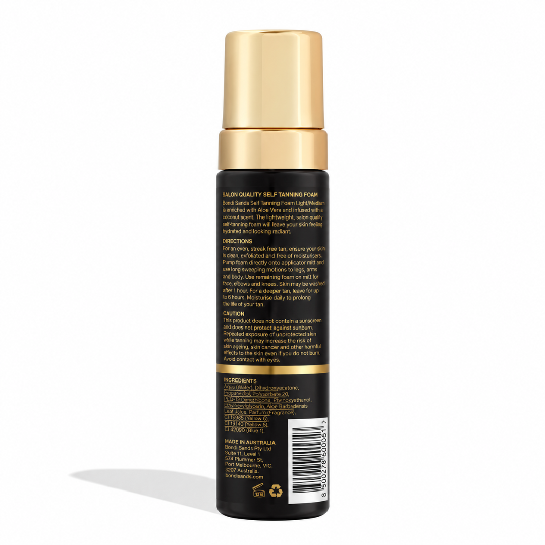 A bottle of hair color cream shown from the back, featuring a black body with gold lettering and a metallic gold cap, set against a plain white background.