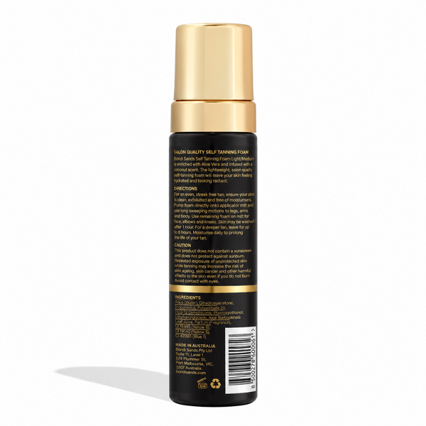 A bottle of hair color cream shown from the back, featuring a black body with gold lettering and a metallic gold cap, set against a plain white background.