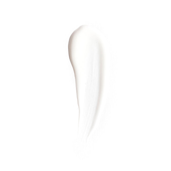 A thick, smooth swipe of white cream or cosmetic product on a solid white background.