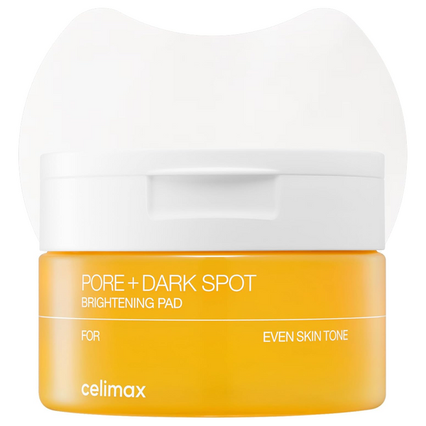 A bright yellow skincare pad container with a white lid, labeled 'PORE + DARK SPOT BRIGHTENING PAD' by celimax, on a white background.