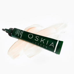 OSKIA CityLife I-Zone Lip & Eye Balm tube on top balm spread on a white surface