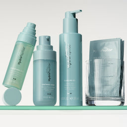 Set of skincare products on a shelf with a light gray background
