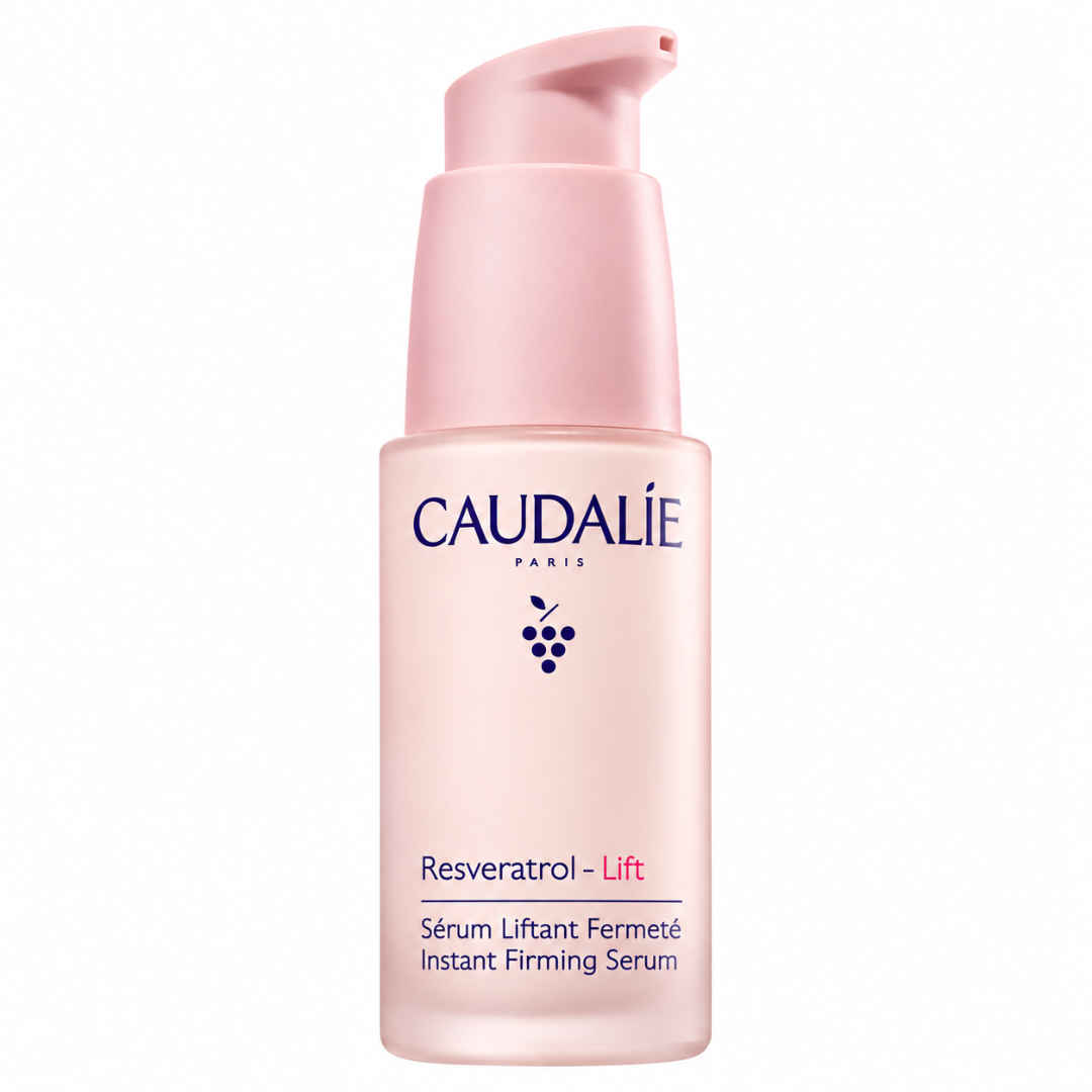 Caudalie Resveratrol Lift Instant Firming Serum in a pale pink pump bottle with a matching pump dispenser, set against a plain white background.