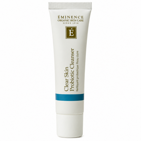 A white squeeze tube of Eminence Organic Skin Care Clear Skin Probiotic Cleanser with gold text and a blue accent band, centered on a white background.
