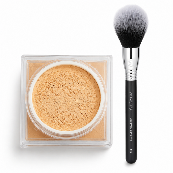 Sigma All-Over Powder makeup in a clear square compact next to a black Sigma brush with a silver ferrule, on a white background.