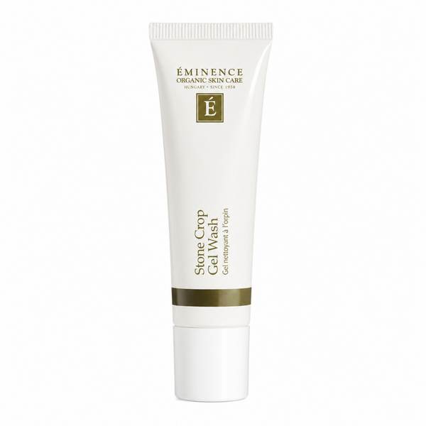 A white squeeze tube of Eminence Organic Skin Care Stone Crop Gel Wash, featuring gold lettering and a gold accent band near the bottom, set against a plain white background.