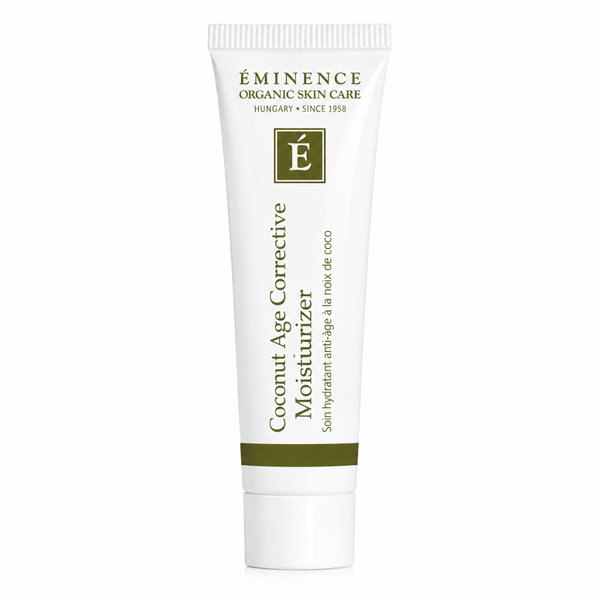 A white squeeze tube of Éminence Organic Skin Care Coconut Age Corrective Moisturizer with dark green text and a green accent band, set against a plain white background.