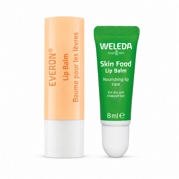 Two lip balm tubes standing upright on a white background: an orange-and-white Everon tube on the left and a green-and-white Weleda Skin Food Lip Balm tube on the right.