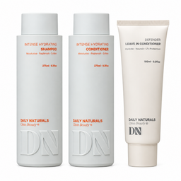 Three Daily Naturals Gloss Beauty hair care products on a white background: two white bottles of intense hydrating shampoo and conditioner, and one off-white tube of defender leave-in conditioner.