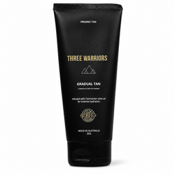 A 300g squeeze tube of Three Warriors Gradual Tan hair product in 'Organic Tan' shade, featuring a matte black tube with gold and white text, set against a plain white background.
