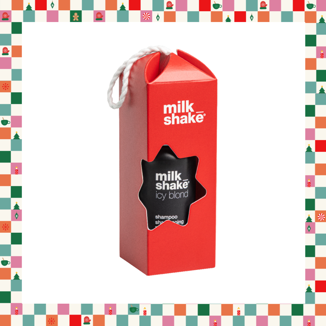 A red Milk Shake Icy Blond shampoo box with a white hanging loop, shown on a white background with a colorful Christmas-themed border.