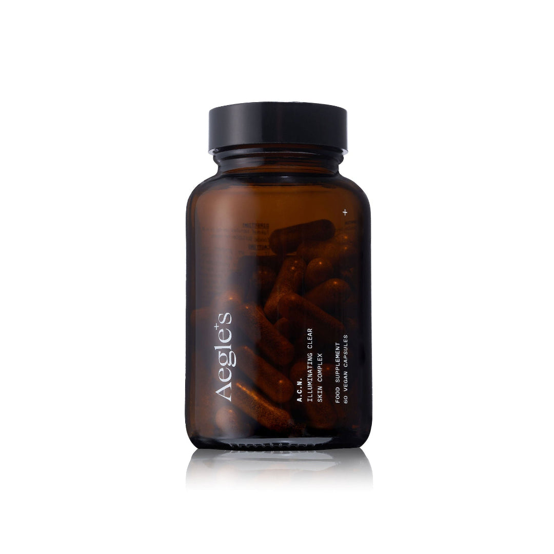 Brown supplement bottle with Aegles branding on a white background, featuring various awards.