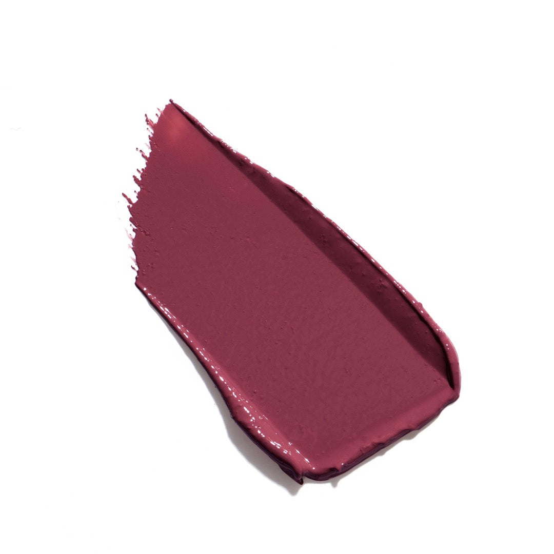 A hydrating cream lipstick by Jane Iredale with a pink hue, displayed in an open bullet form with a gold twist cap.