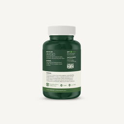 A dark green supplement bottle with a white cap, showing the back label with usage, storage, and warnings, on a light off-white background.