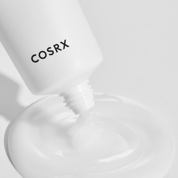 COSRX AC Collection Lightweight Soothing Moisturizer being poured onto a white surface