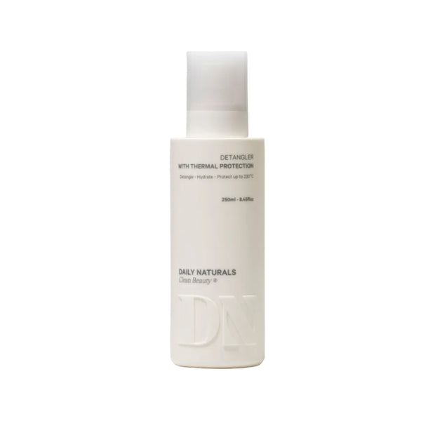 White bottle of Daily Naturals detangler on a light gray background