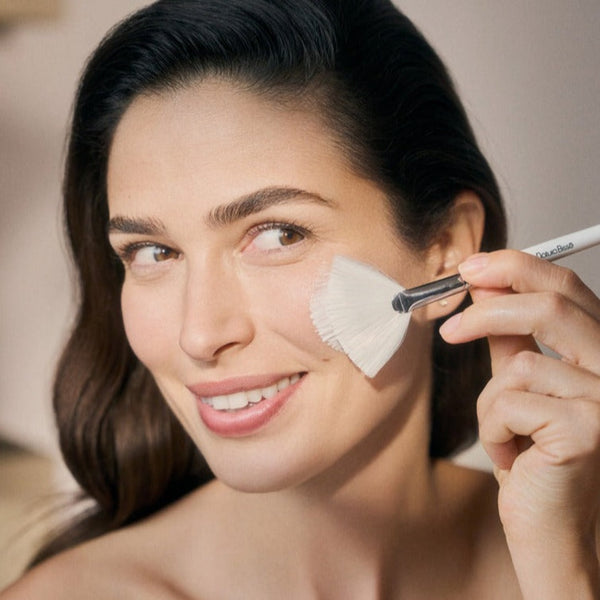 a model applying Natura Bisse Diamond Luminous Glowing Mask to her face