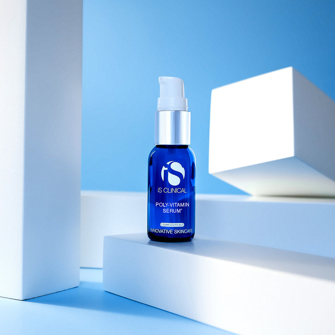 Blue serum bottle on a white platform with a blue background