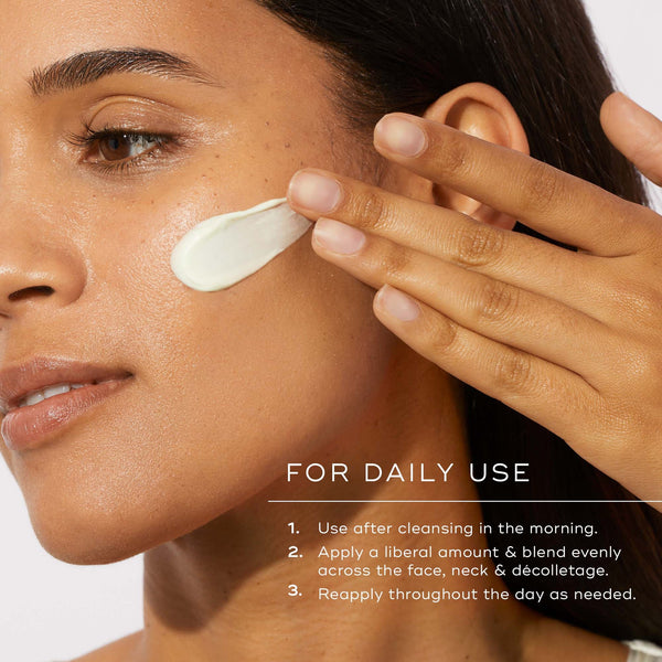 a model applying the cream to her face