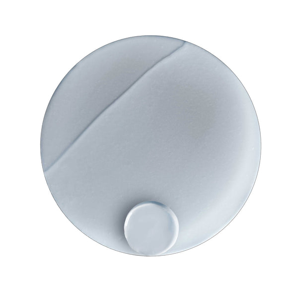 White round object with a central indentation on a white background