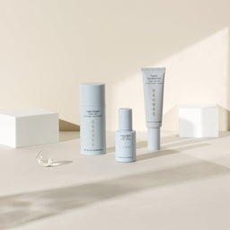 collection of Decree AM Essentials in front to two white cubes