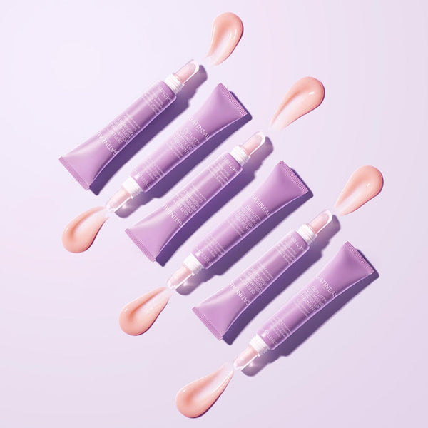 6 Gatineau Defi Lift Volumising Peptide Lip Treatment tubes arranged side by side with their contents poured out slightly 