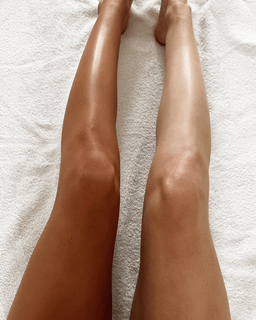 a models legs with one that has no bronzing and one with
