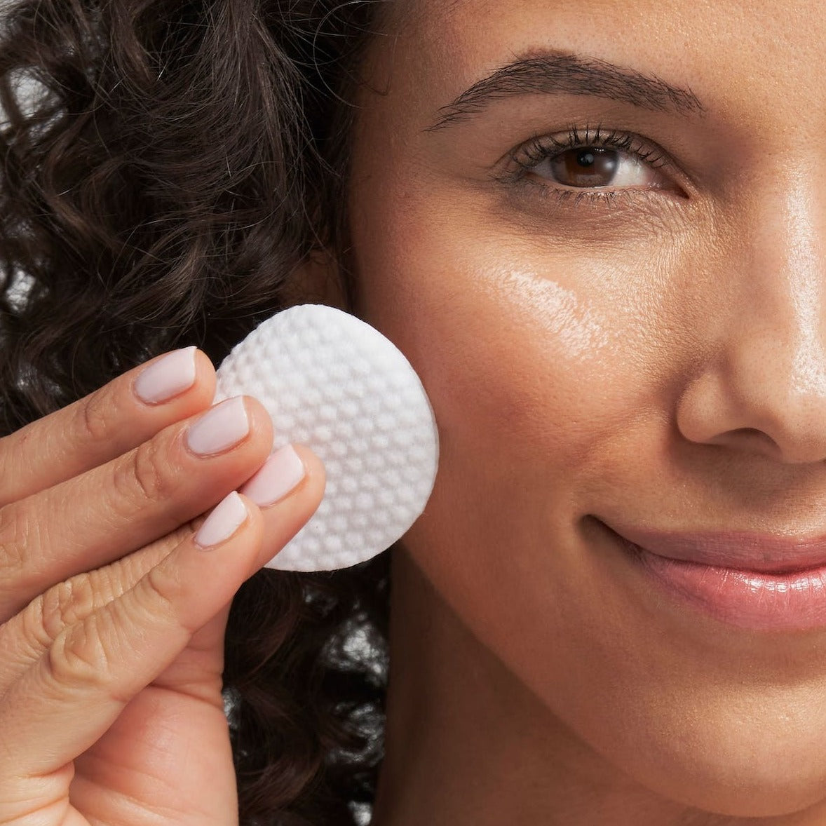 model holding a pad to her face
