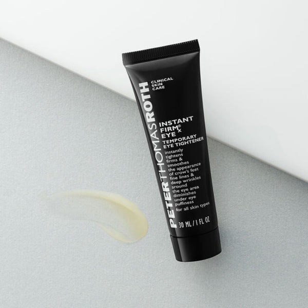 Peter Thomas Roth Instant FIRMx Eye Temporary Eye Tightener tube with a smudge of texture next to the tube