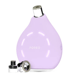 A light purple FOREO hair dryer attachment with a silver metal nozzle and a separate black and silver nozzle accessory, shown on a plain white background.