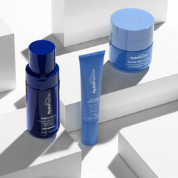 Blue skincare products on a white geometric background