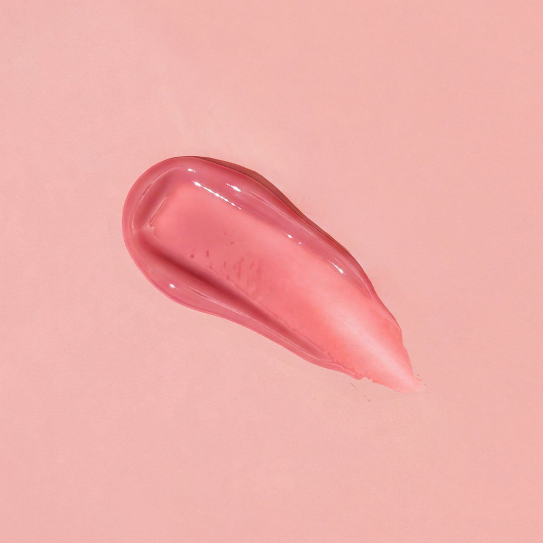 Pink lip balm smear on a pink background
