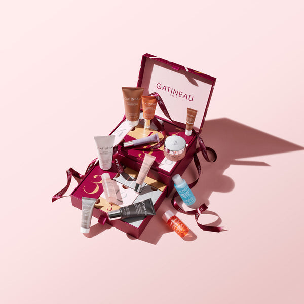 Gatineau skincare products in a box on a pink background
