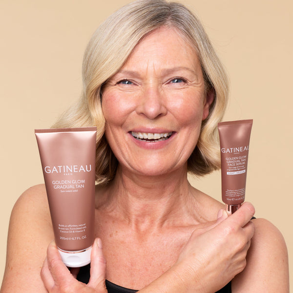 Woman holding two Gatineau skincare products against a beige background