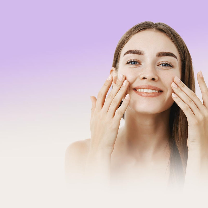 Model using skincare on her face