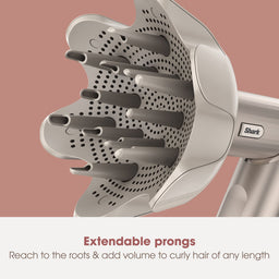 Shark hair dryer with extendable prongs on a pink background